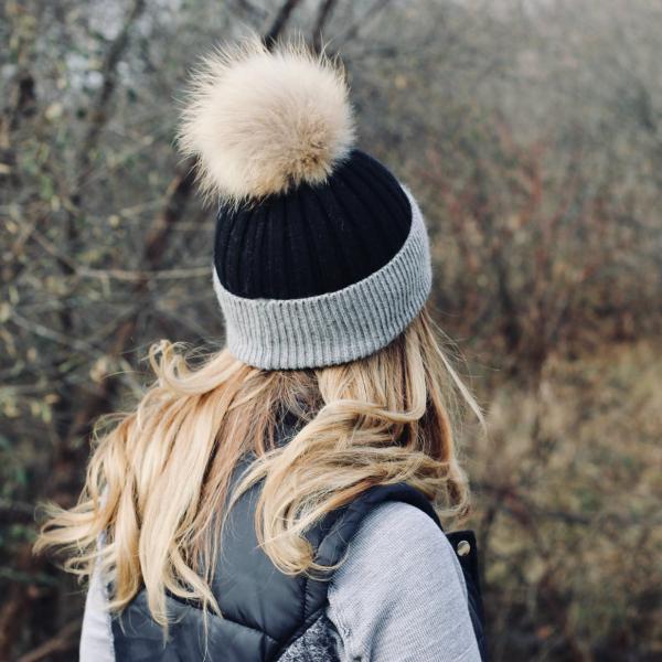 Angora knit beanie with white fur pom; dark knit body and ribbed cuff