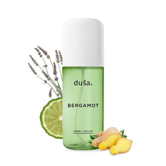 Bergamot hair and body perfume mist bottle with citrus slice and lavender sprig