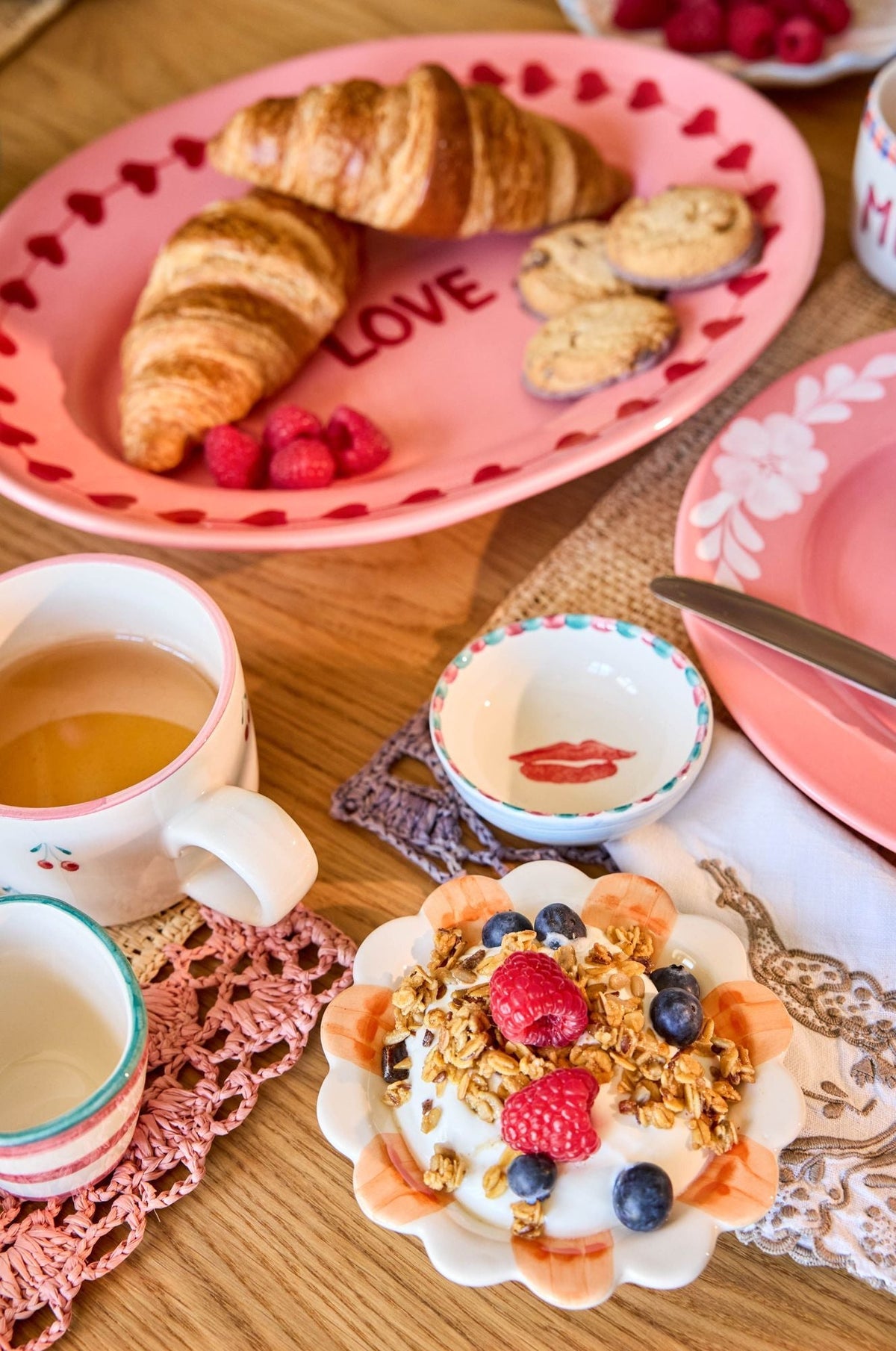 Pink ceramic plate with LOVE heart text and pastries, plus small dipping bowl