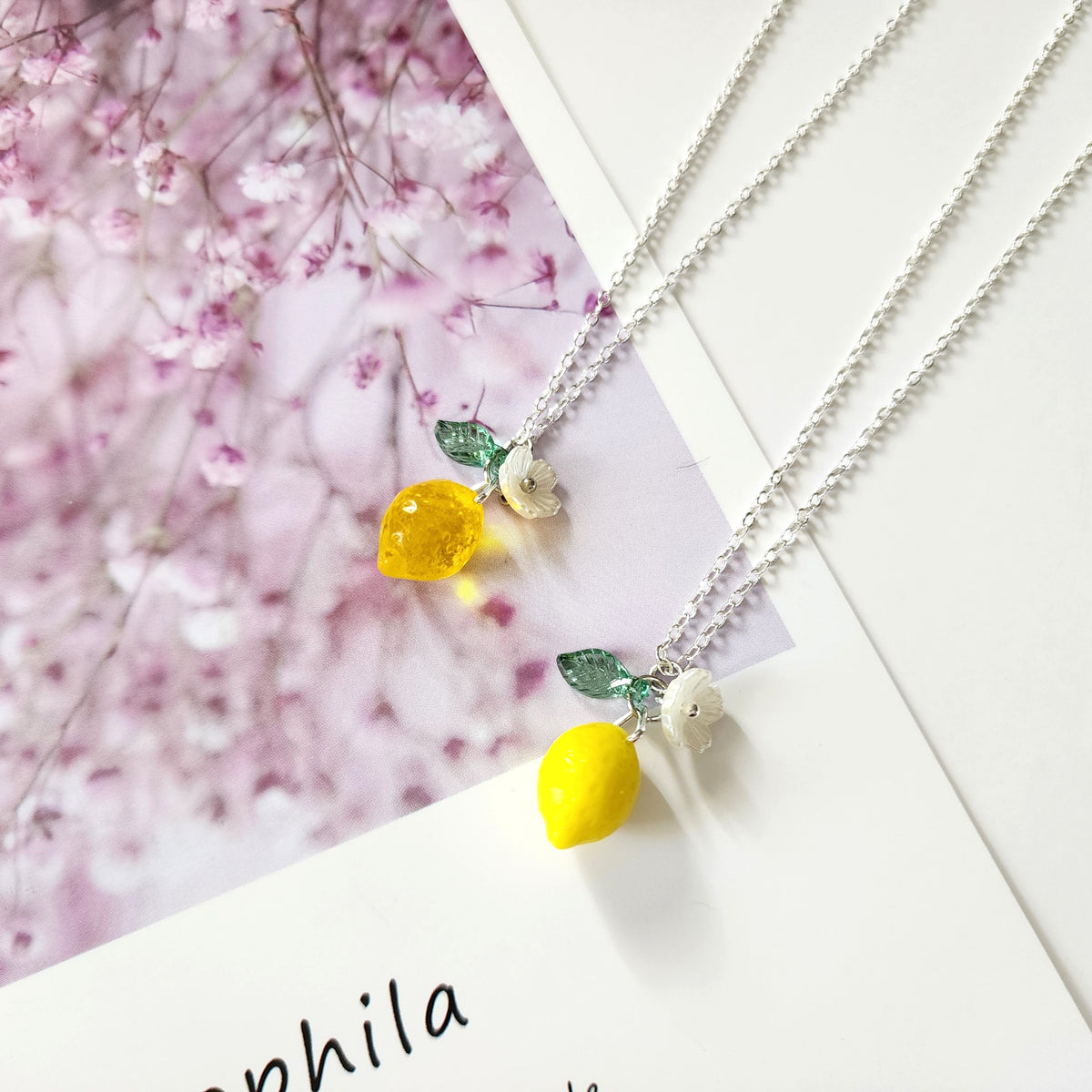 Lemon fruit necklace set with yellow lemon pendants, white flowers, and green leaves