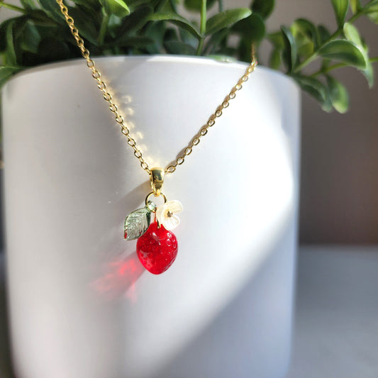 Gold mini strawberry fruit necklace with white flower and green leaf pendant on chain
