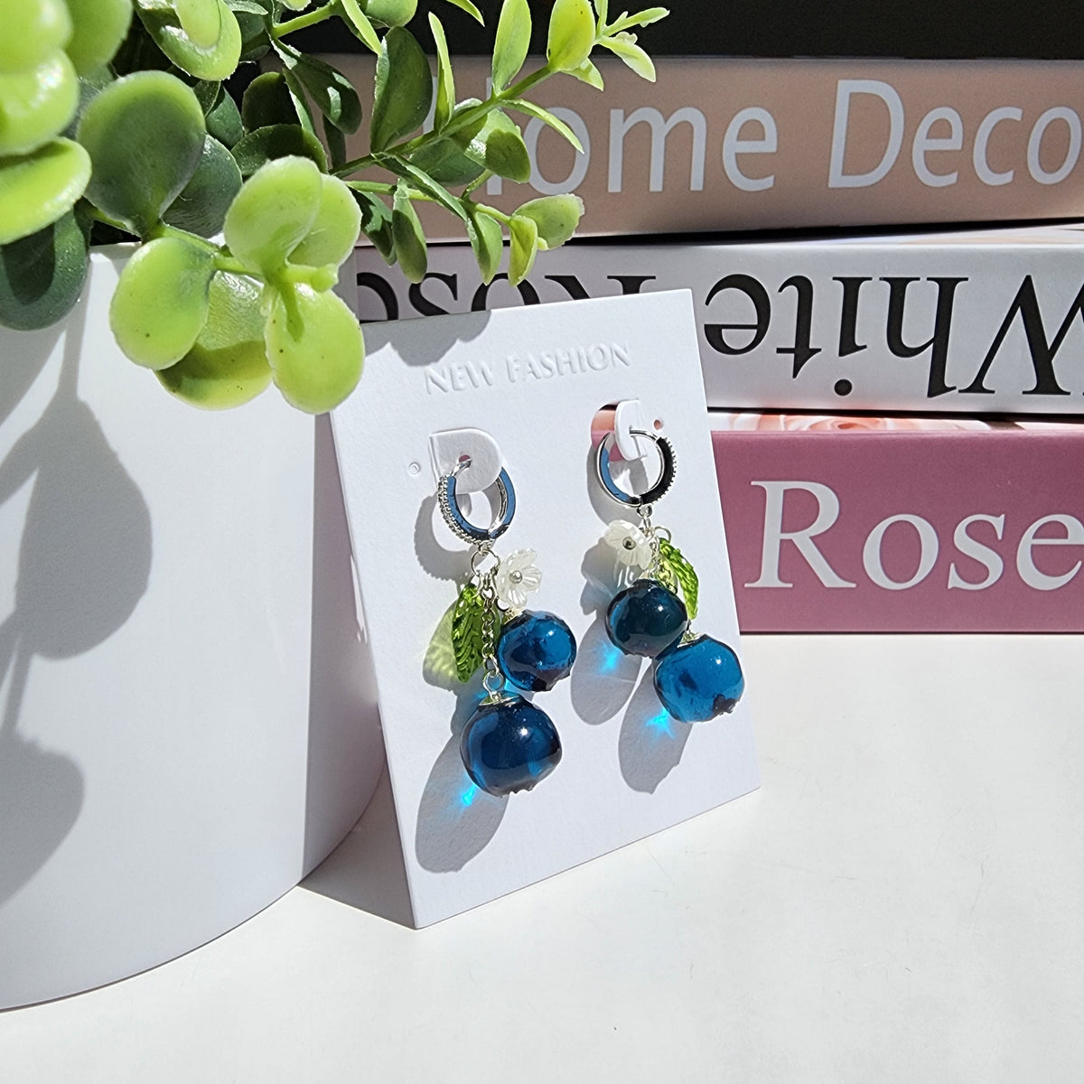 Blueberry cluster dangle earrings with blue resin berries, green leaves, white flowers, gold hoops