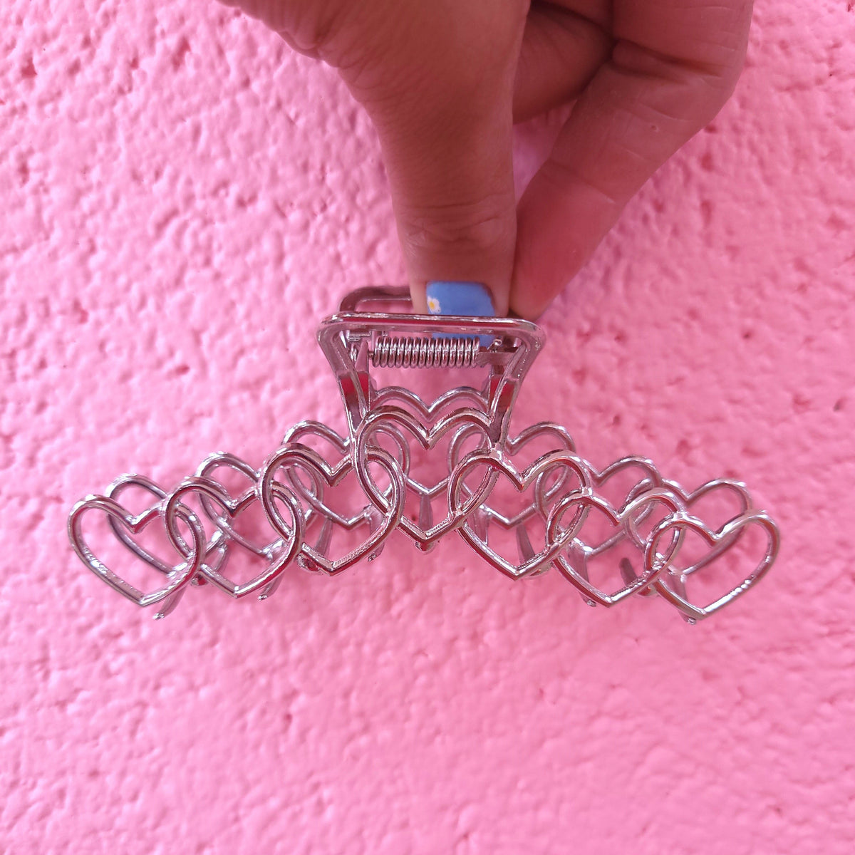 Silver heart hair claw with small heart links and clear top clip.