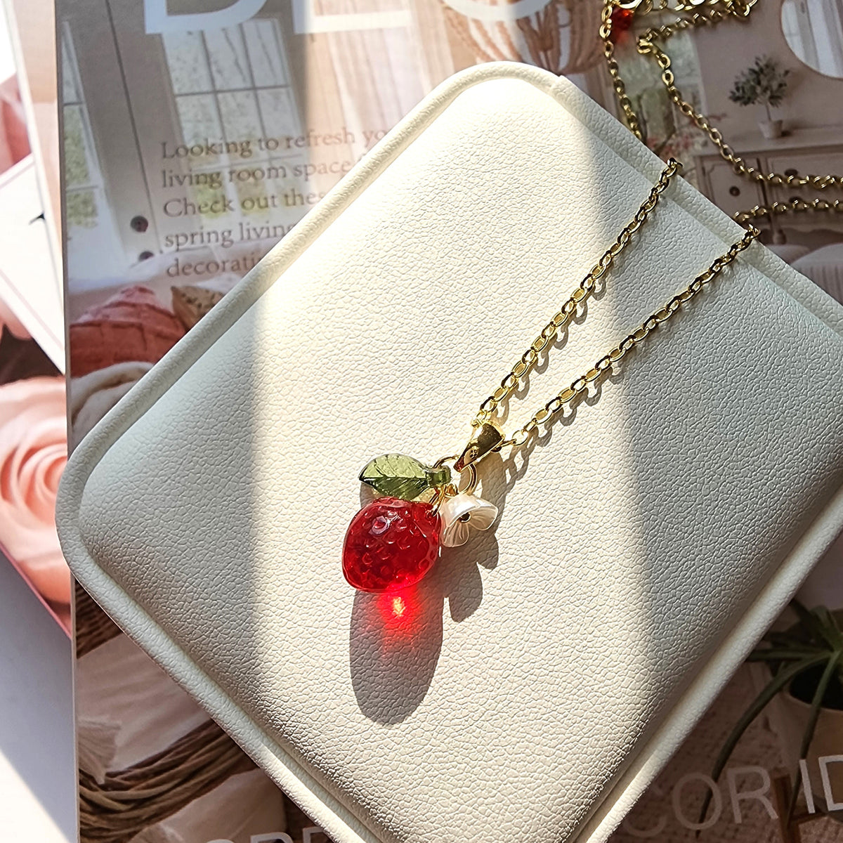 Gold mini strawberry pendant necklace with layered chains, white flower and leaf charms