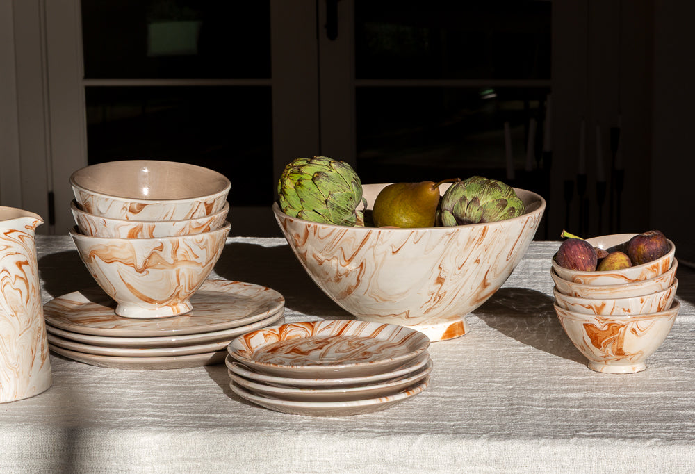 Marbled ramen bowls with orange swirl pattern, grouped with matching side bowls