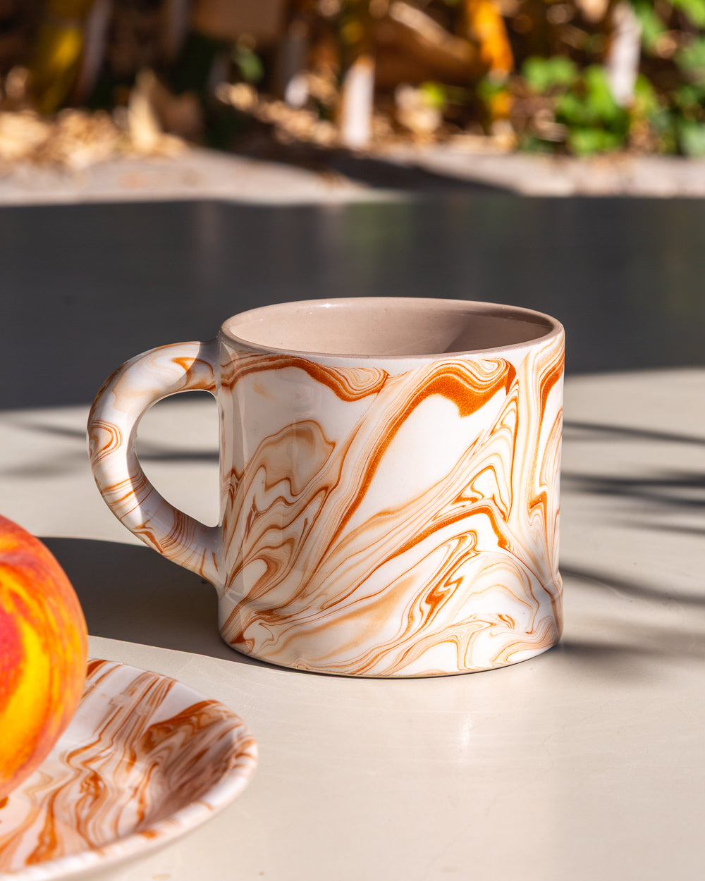 Marbled Terra mug, white with orange-and-brown marbling, side view with curved handle