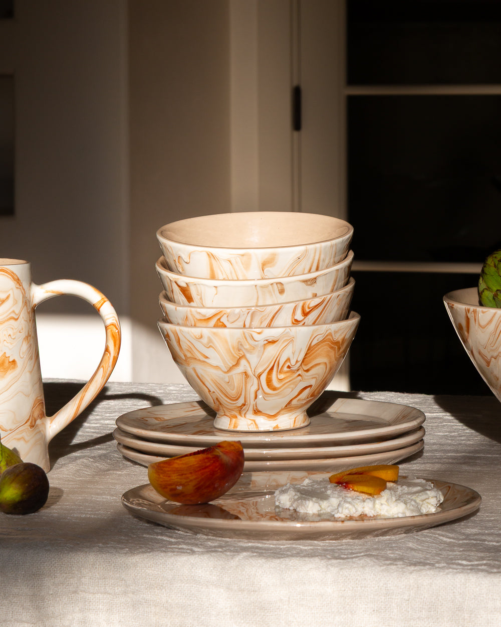Marbled ramen bowls with orange swirl pattern, three stacked on a serving plate