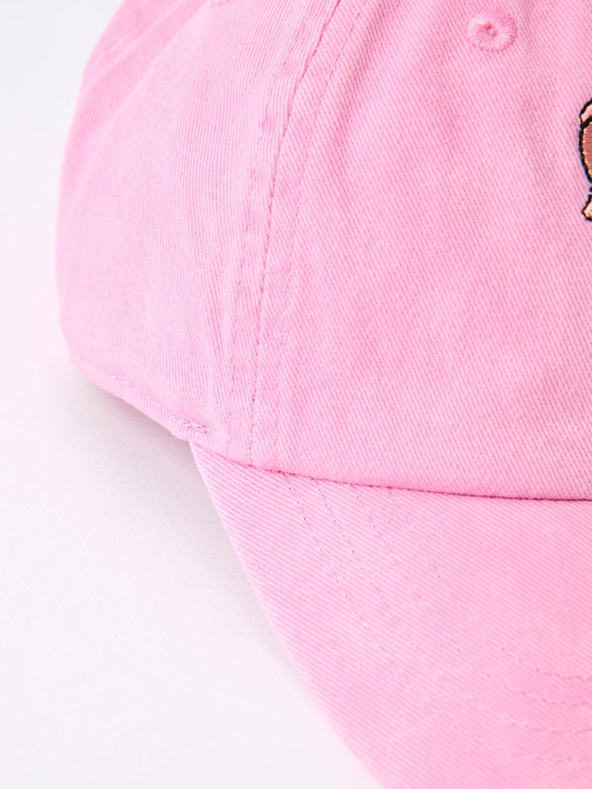 Pink girls baseball cap panel detail with stitching and small eyelets