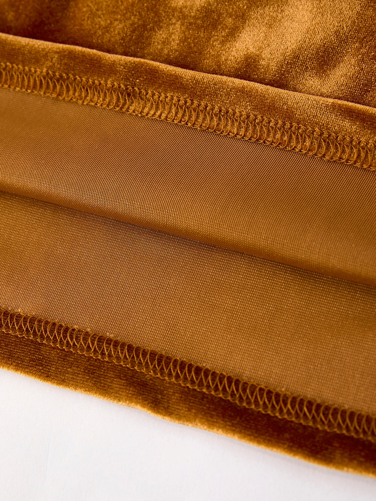 Girls velvet dress hem detail in brown-gold with stitched elastic trim