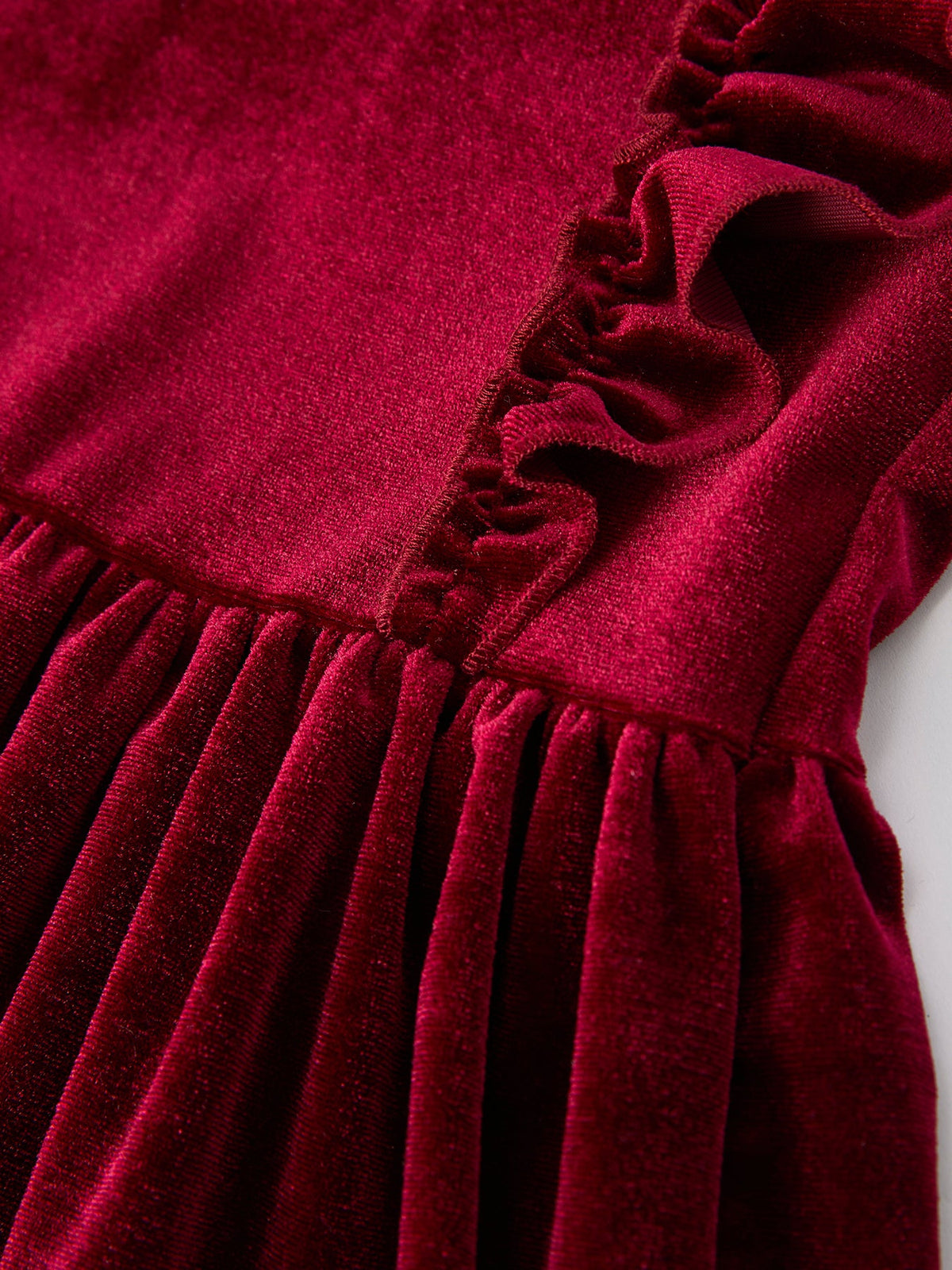 Girls velvet dress bodice and skirt detail in burgundy with gathered pleats