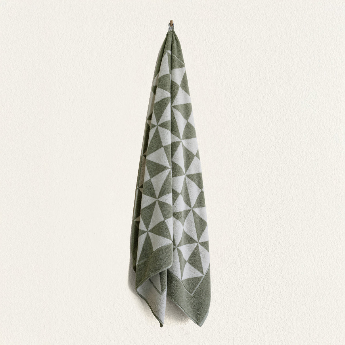Green and ecru geometric cotton hand towel with mitered corners