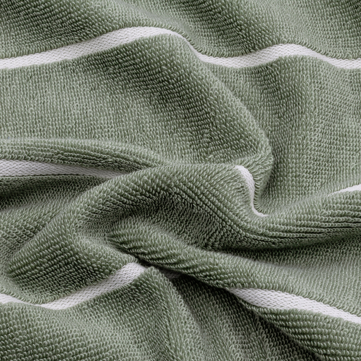 Close-up of sage green cotton towel fabric with ecru trim detail