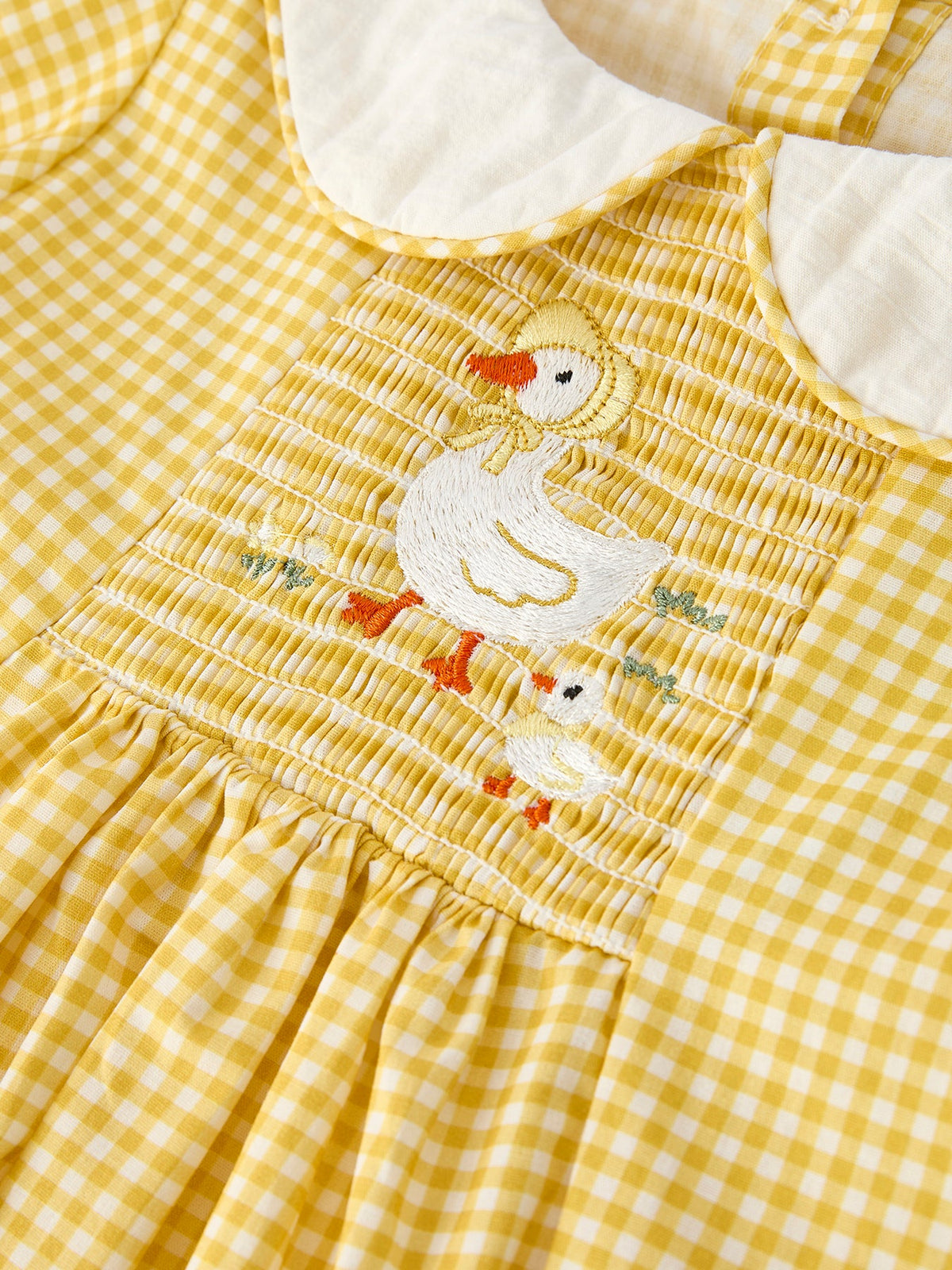 Yellow gingham smocked yoke with embroidered white goose and colorful accents