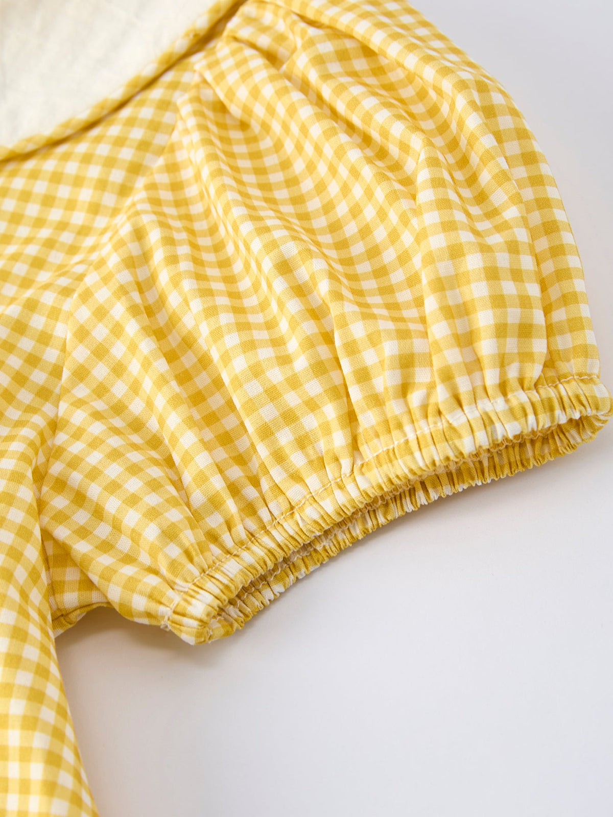 Yellow gingham dress sleeve with elastic cuff and gathered skirt hem