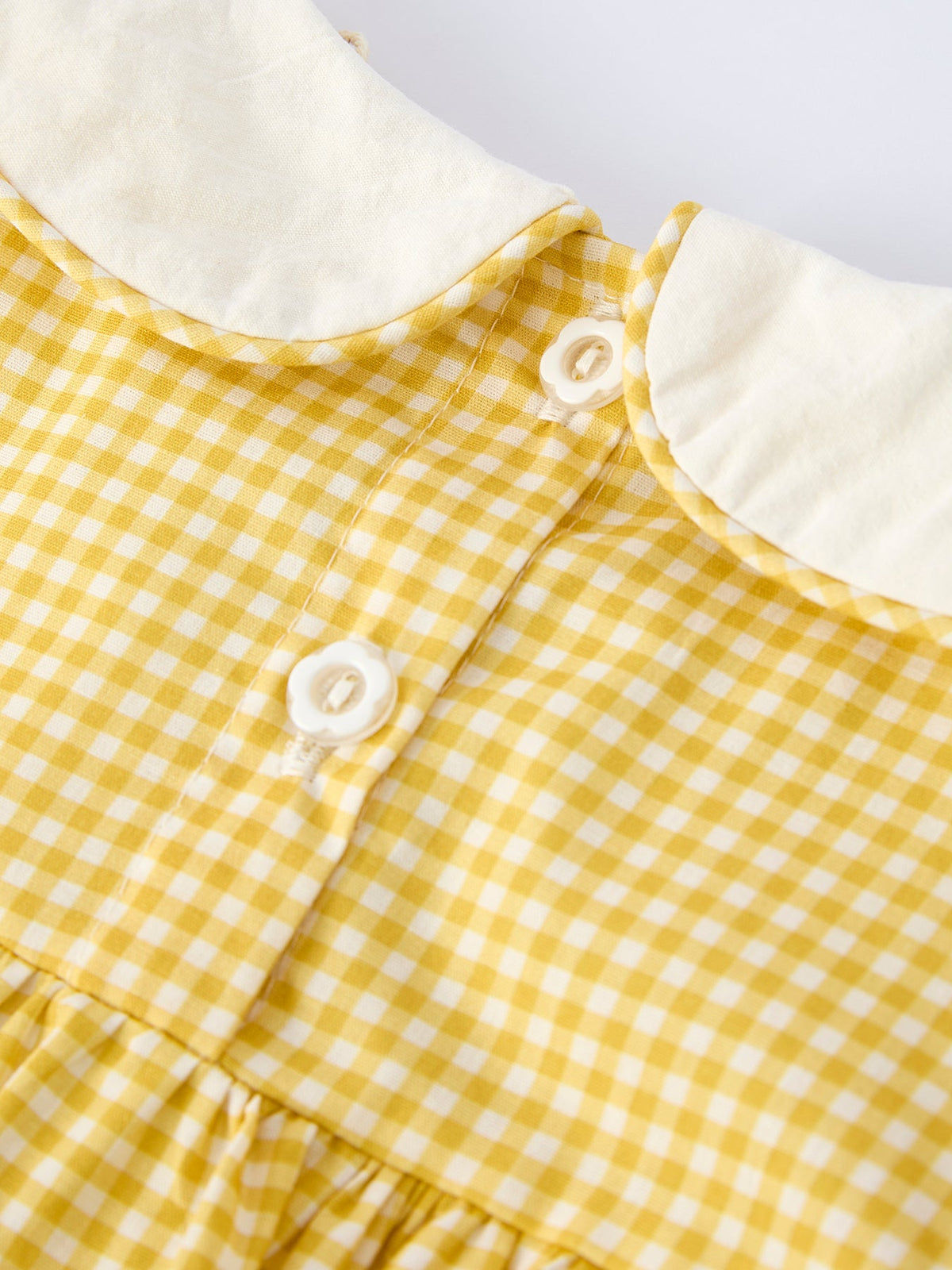 Yellow gingham dress with white Peter Pan collar and button placket