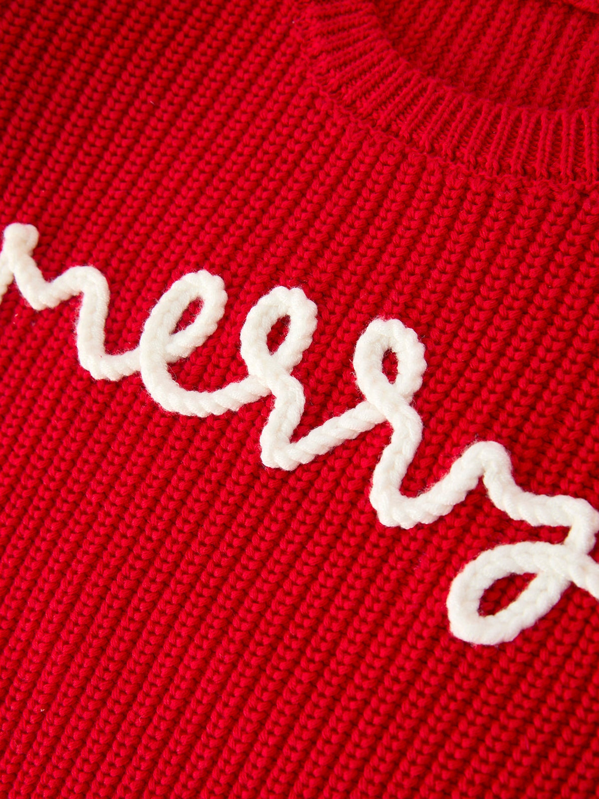 Red knit sweater with white 'merry' cursive applique lettering