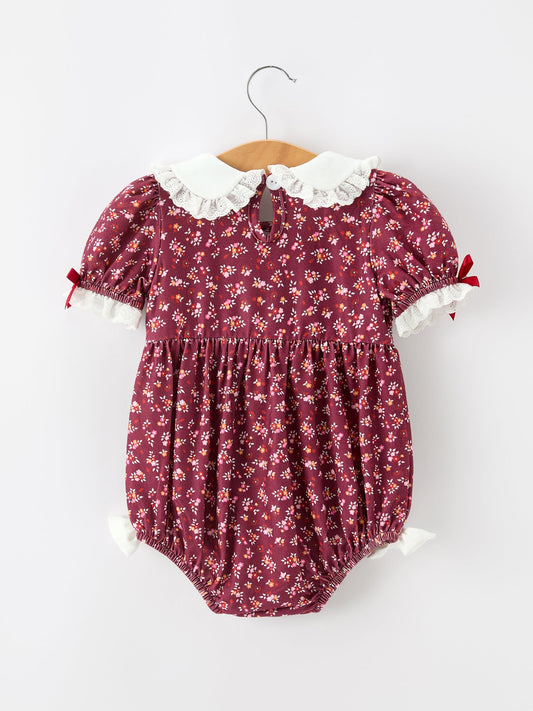 Burgundy floral bubble romper with Peter Pan collar, gathered waist, and white lace-trim cuffs.