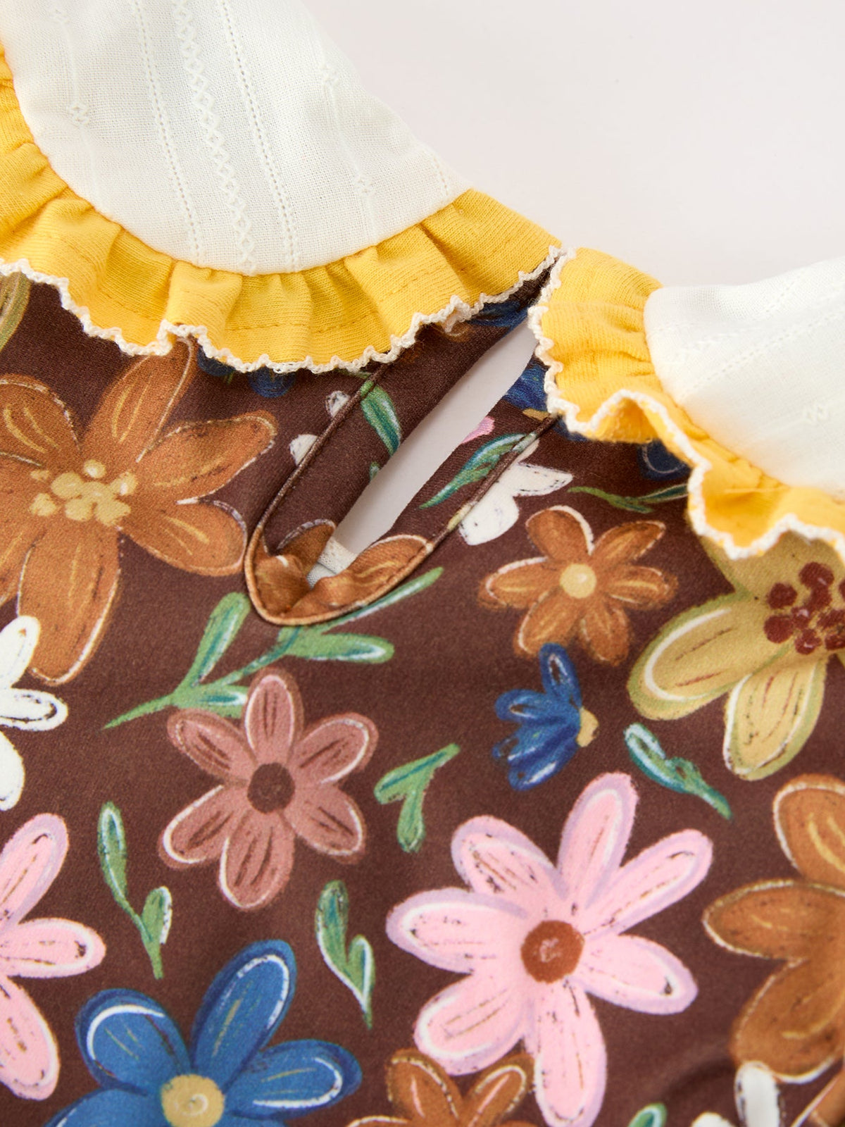 Floral dress neckline with white panel and yellow ruffle edging
