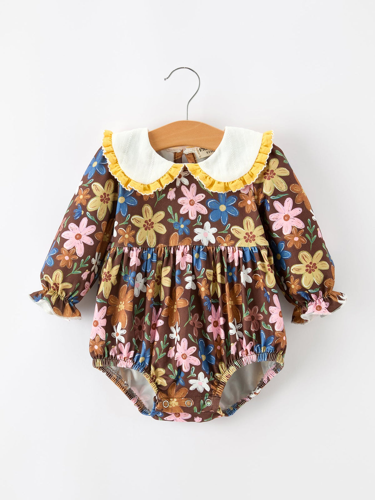 Brown floral baby romper with white Peter Pan collar, long sleeves, ruffled cuffs