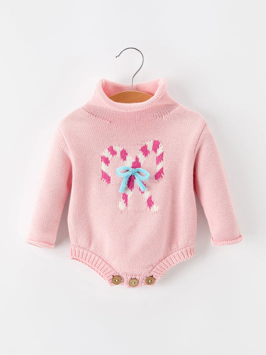 Pink knit baby romper with candy cane bow graphic and snap buttons at legs
