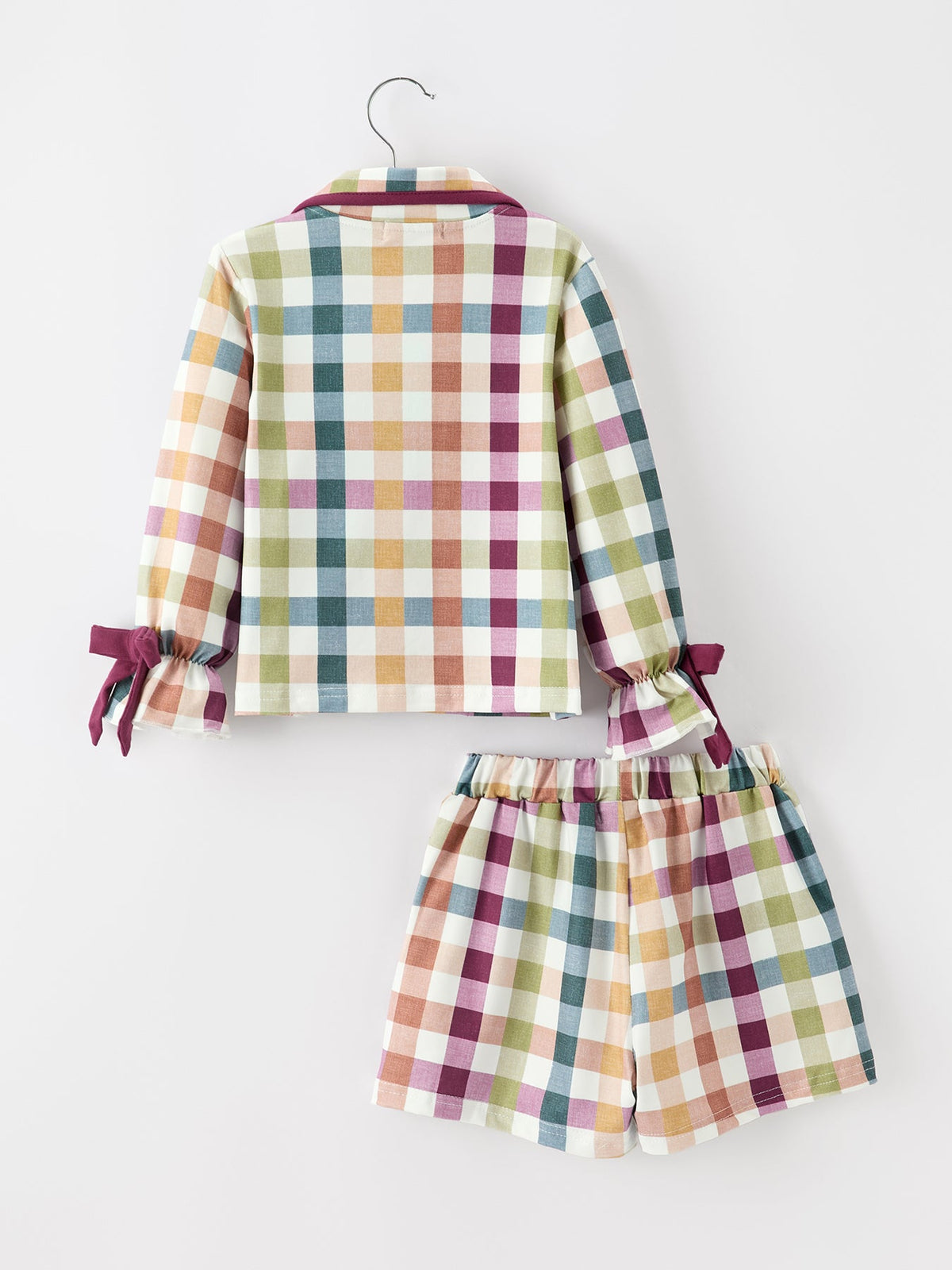 Multicolor plaid pajama set with maroon trim; long-sleeve top and tie-front shorts, back view