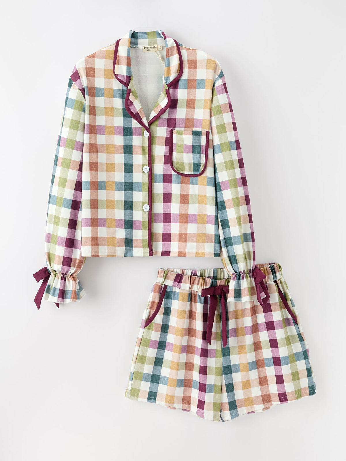 Plaid pajama set for children on white background: long top with pocket and shorts