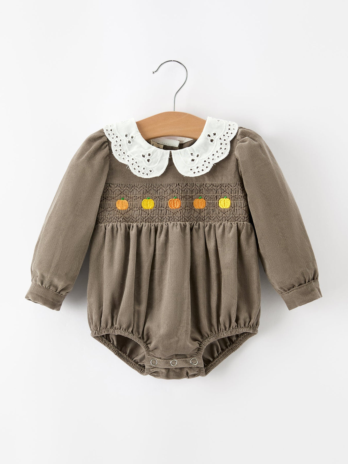 Taupe baby girls romper with white eyelet collar and pumpkin smocked chest