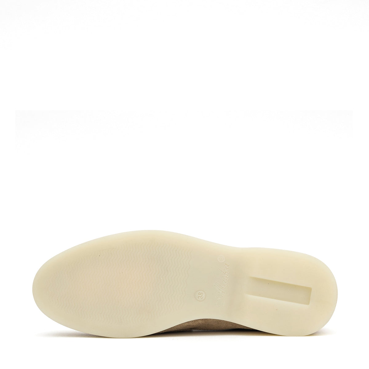 Cream outsole of a beige suede loafer, viewed from below
