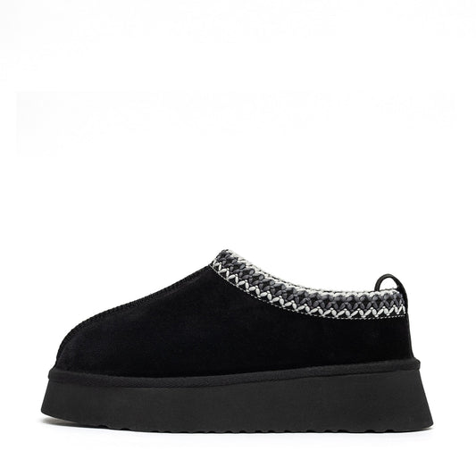 Black shearling slipper in side profile with braided collar and thick sole