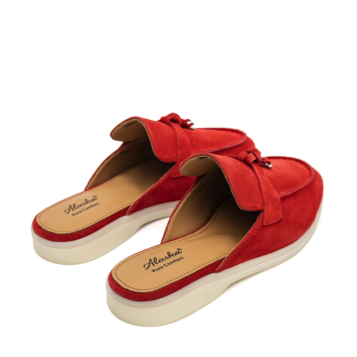Pair of red suede mules showing the tan footbeds and open backs.