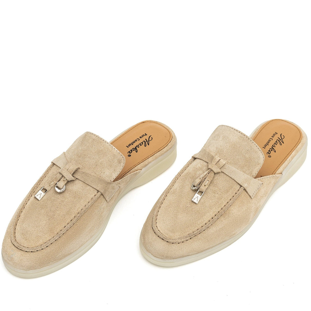 Beige suede mules with stitched apron toes and metal charm details