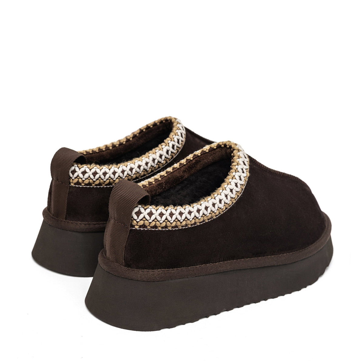 Brown slippers showing plush shearling lining, braided trim, pull tabs, and thick soles