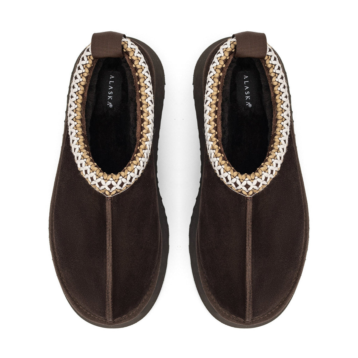 Pair of brown shearling slippers with braided trim and pull tabs, viewed from above
