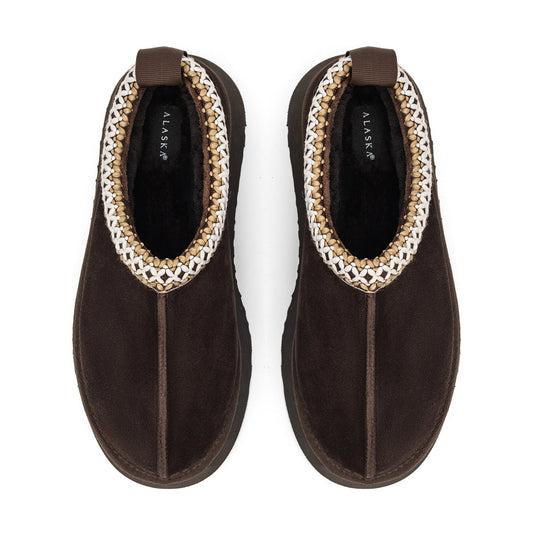 Pair of brown shearling slippers with braided trim and pull tabs, viewed from above