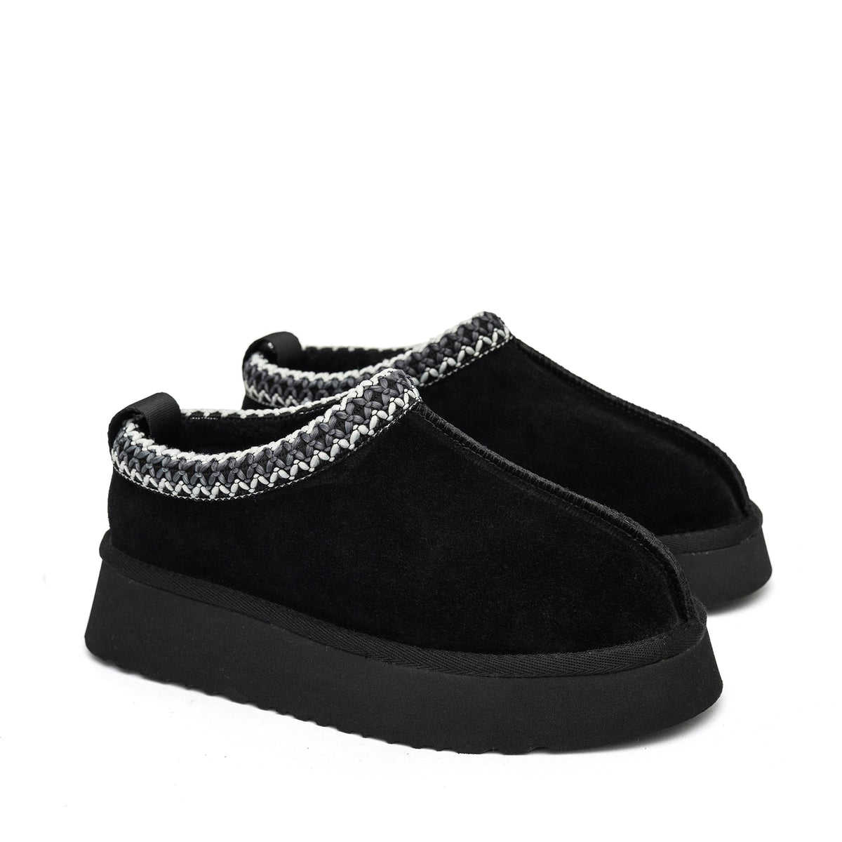 Pair of black shearling slippers showing side profiles and braided collars