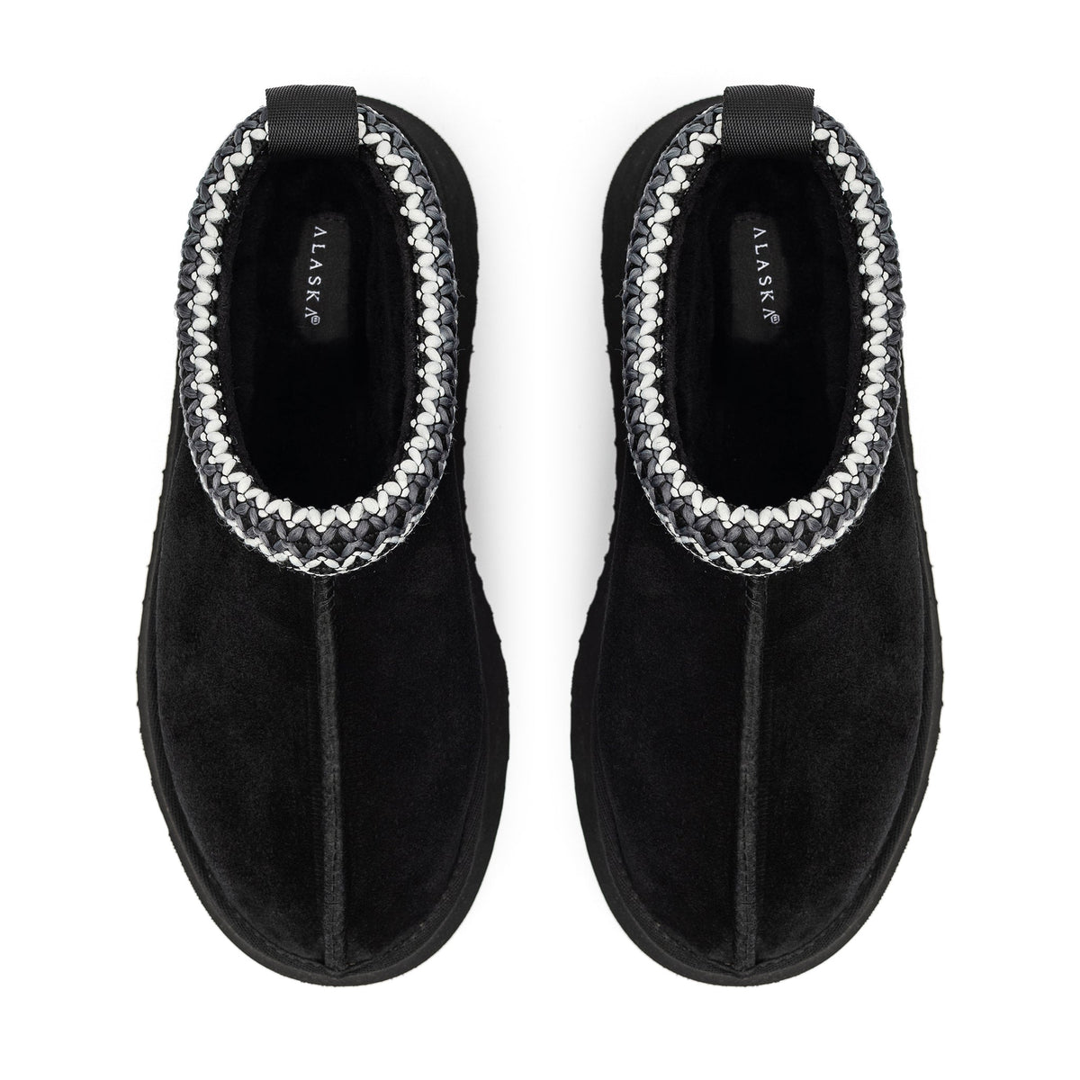 Black Alaska shearling slippers with braided trim, viewed from above