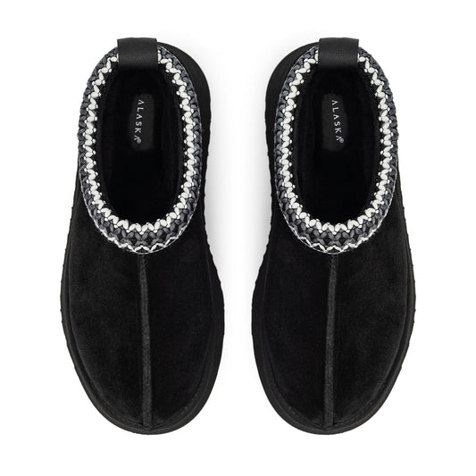 Black Alaska shearling slippers with braided trim, viewed from above