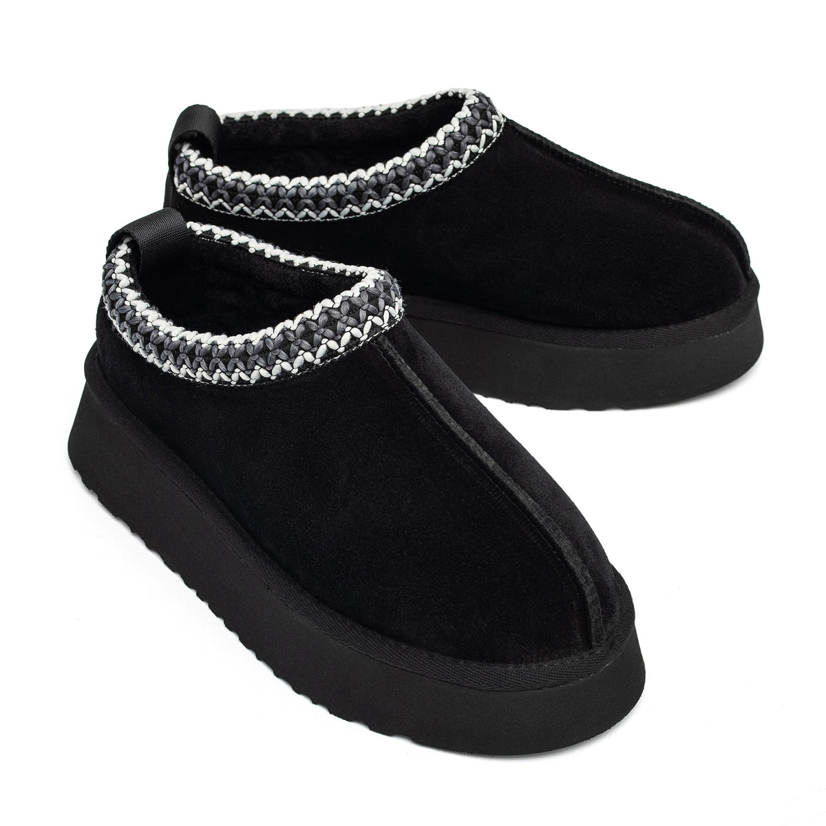 Pair of black shearling slippers at an angle, showing the braided collars