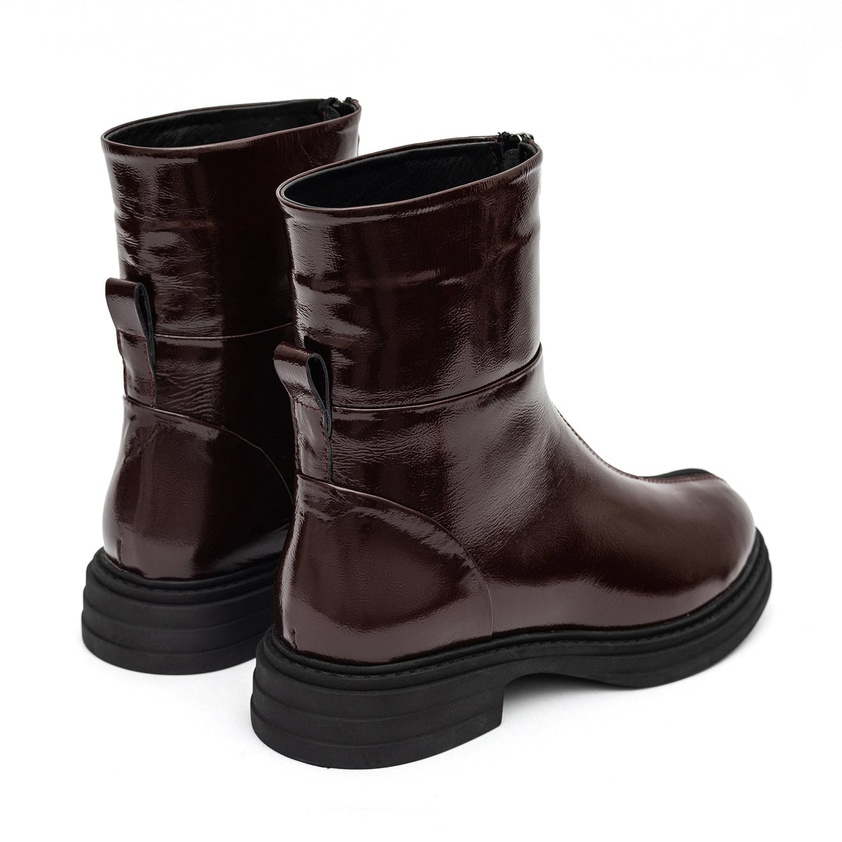 Burgundy leather boots shown from the back, with ankle zippers and block heels