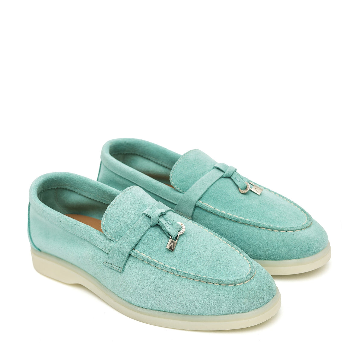 Turquoise suede loafers with stitched apron toes and metal bit accents