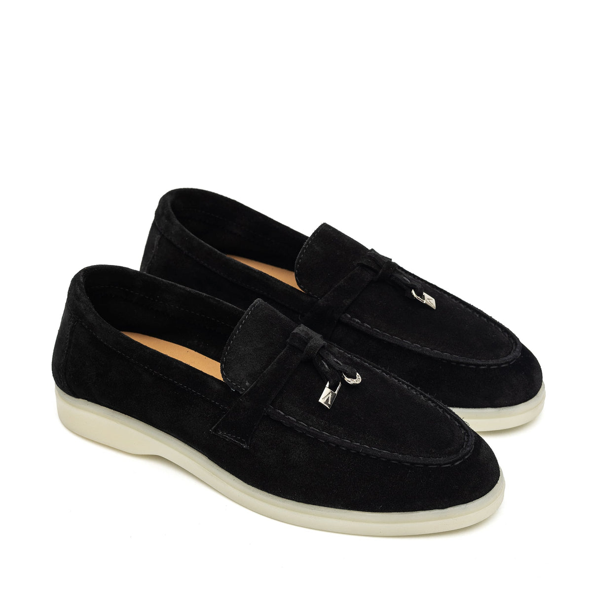 Pair of black suede loafers with stitched apron toes and cream soles