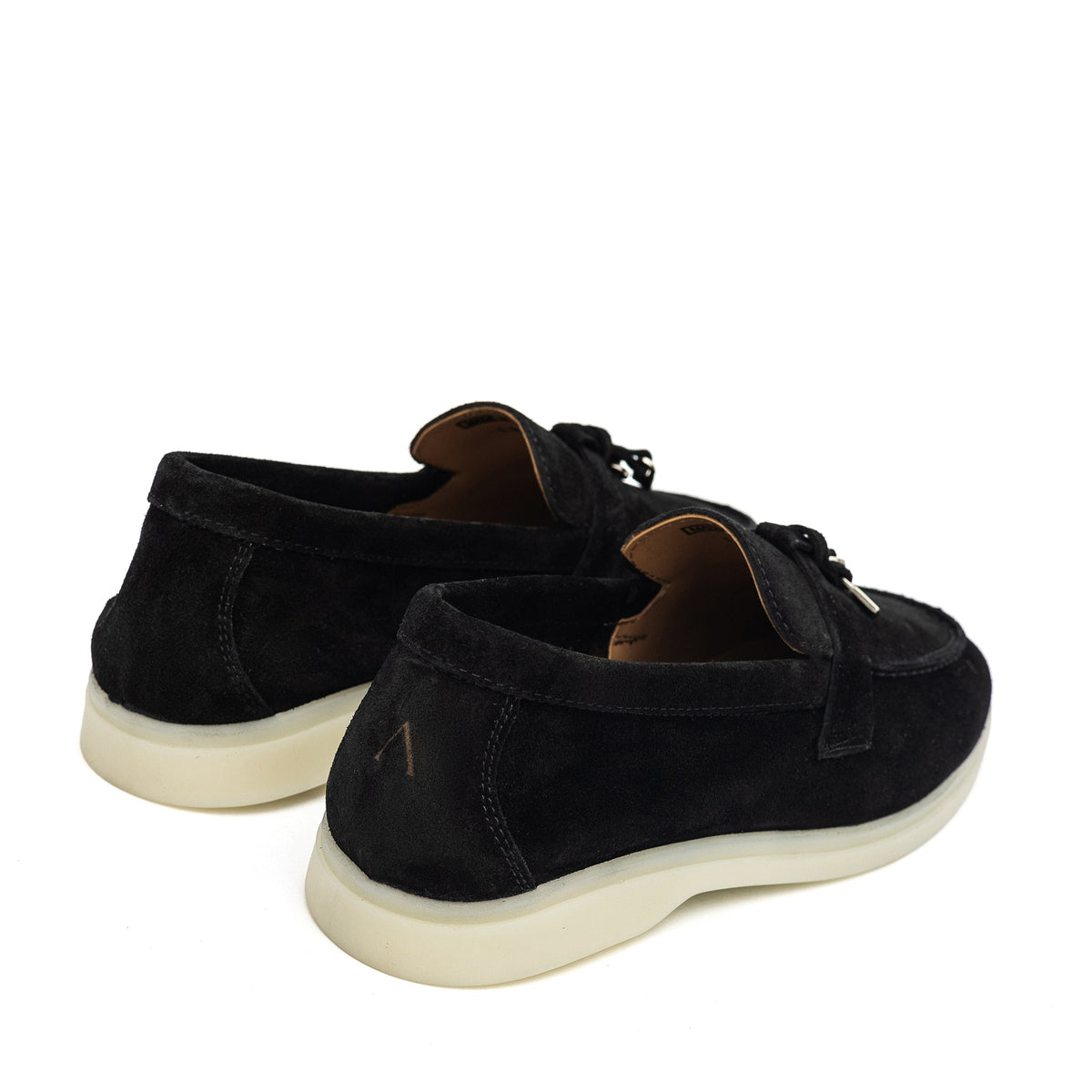 Black suede loafers shown from the back and side, with cream soles