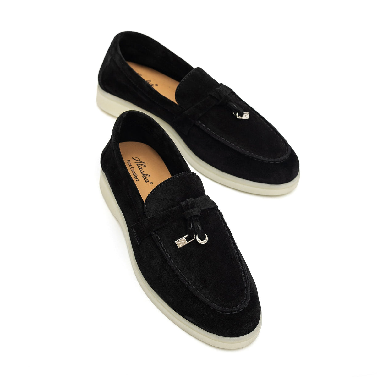 Black suede loafers with cream soles and metal bit details, shown from above