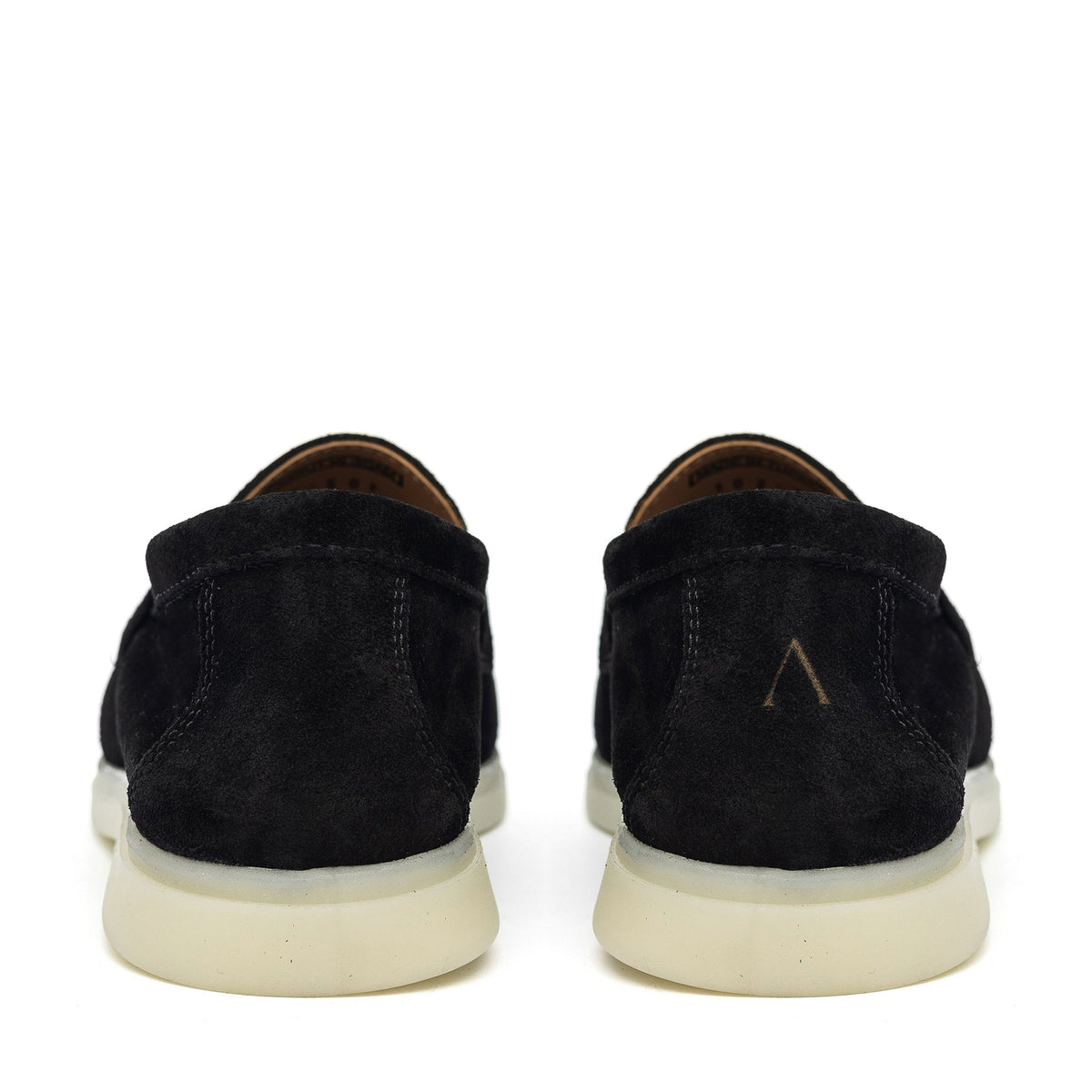 Rear view of black suede loafers with cream soles