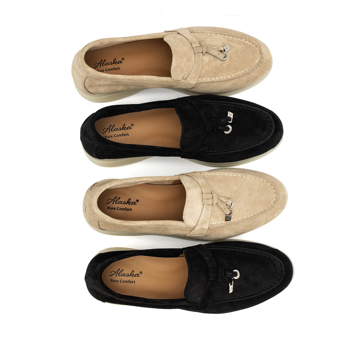 Suede loafers in black and tan with cream soles and metal bit details