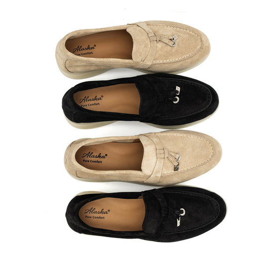 Suede loafers in black and tan with cream soles and metal bit details