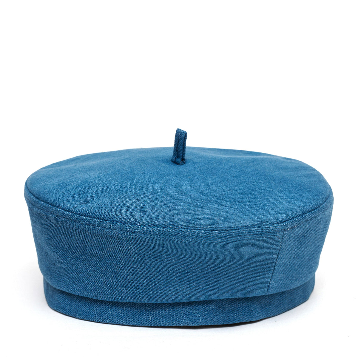 Blue Paris hat shown from the side, with a short brim and top button.