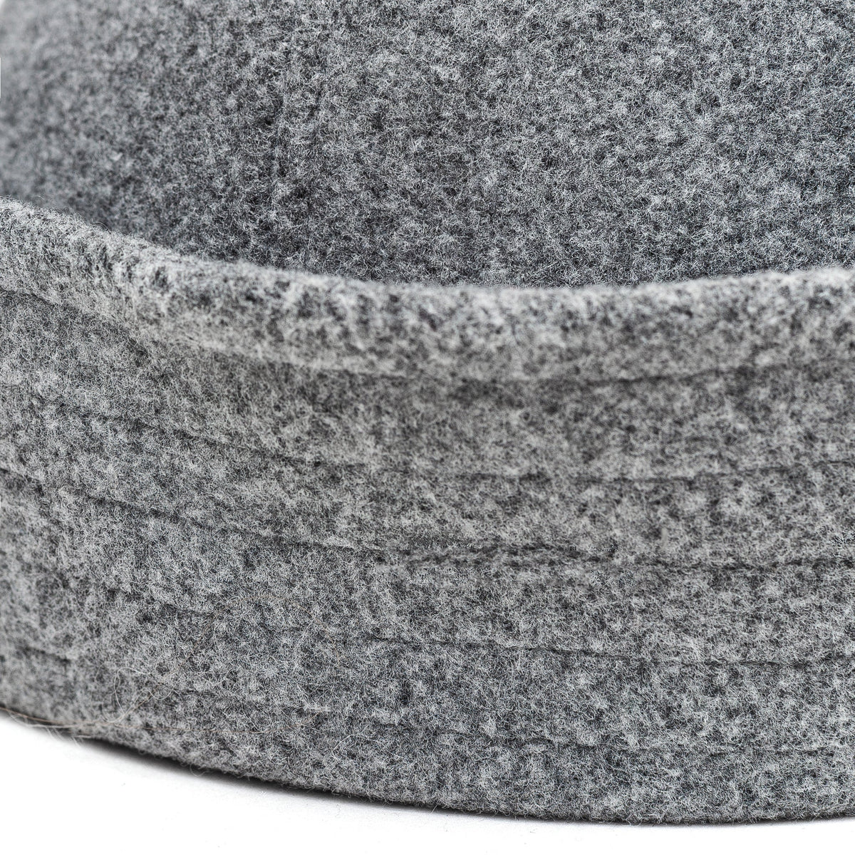 Light grey sailor hat close-up showing the mottled felt texture and stitched band