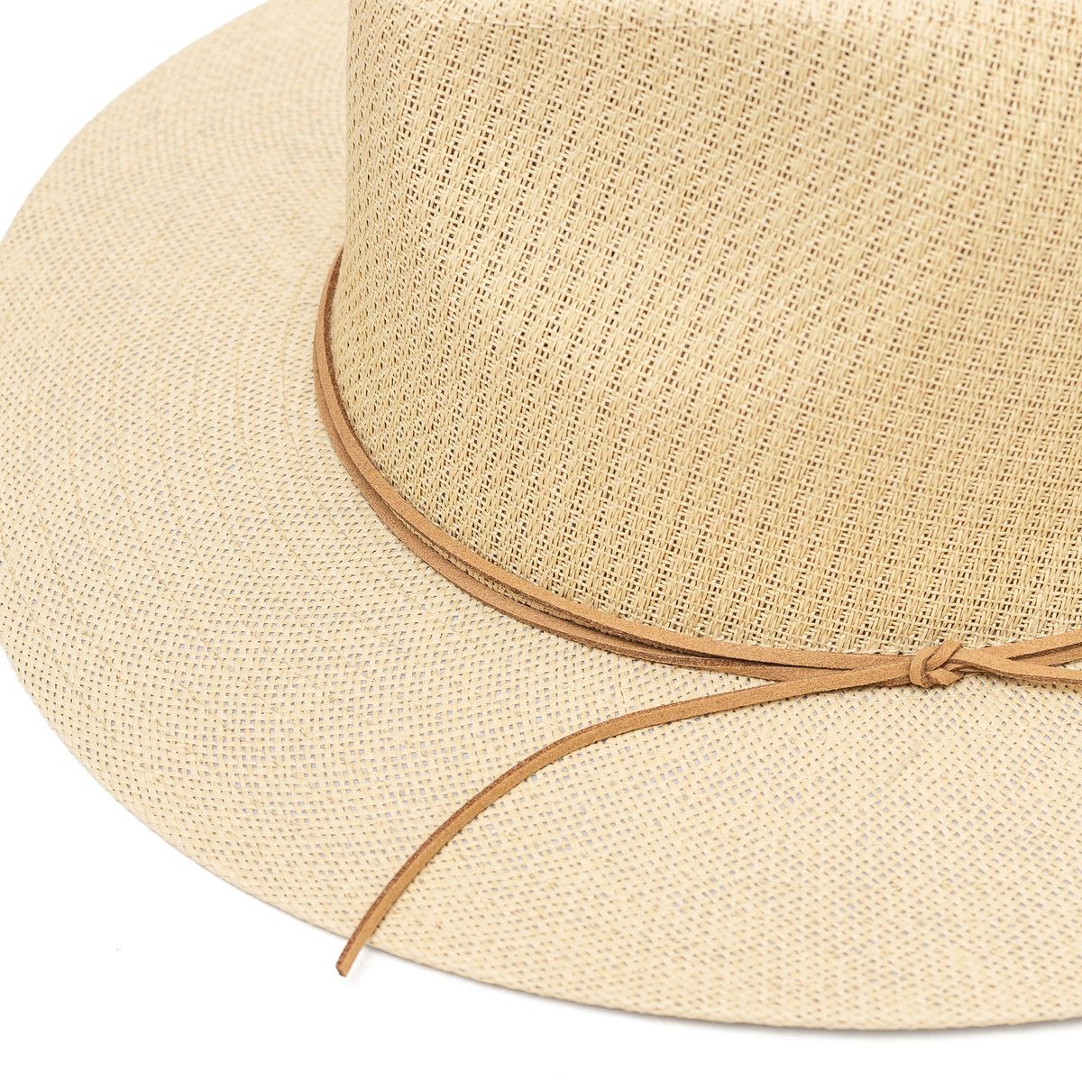 Close-up of woven paper straw, wide brim, and double chain trim on a beige hat