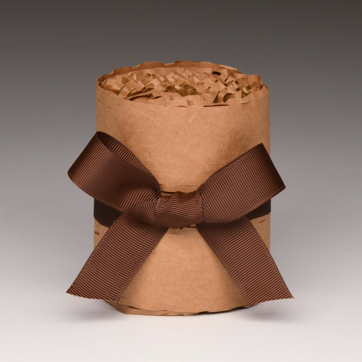 Kraft paper candle gift wrap with two-loop brown ribbon bow